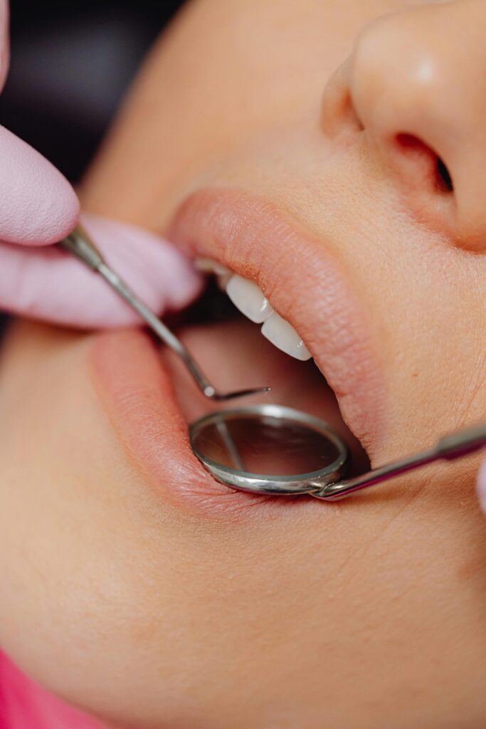 Close-up of a patient receiving a professional dental checkup and mouth examination at Dental Clinic 24 Antalya.